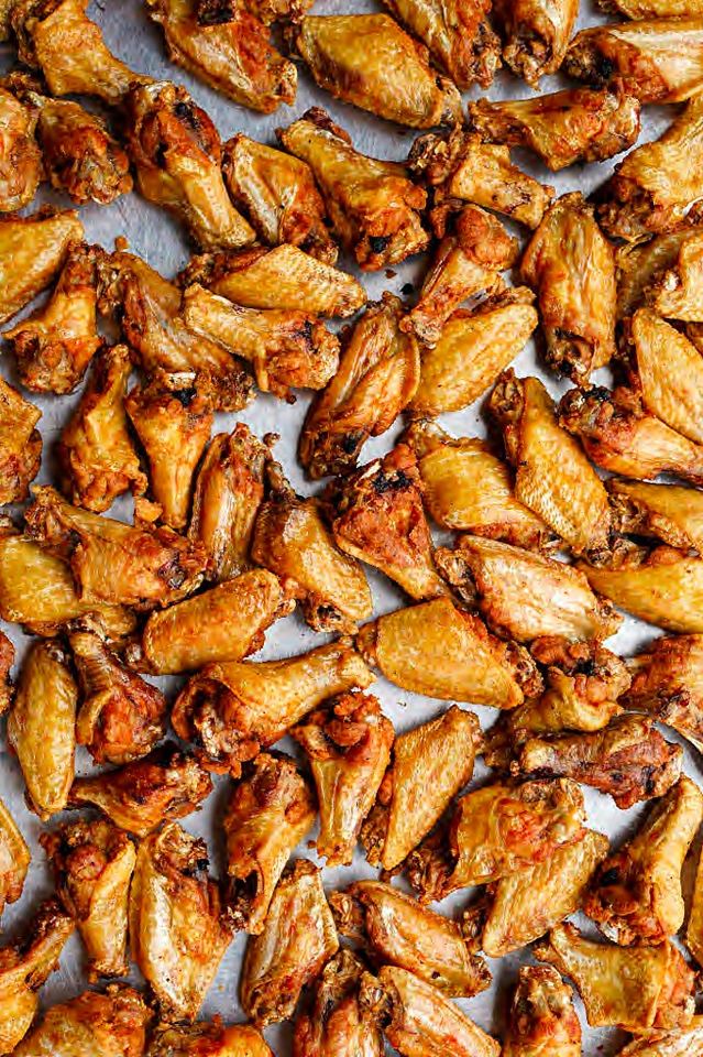 Tray packed with crispy wings fresh from the fryer.